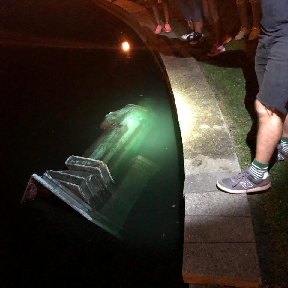 The statue of Christopher Columbus is seen in a lake after it was pulled down by protesters, following the death of George Floyd who died in police custody in Minneapolis, in Richmond, Virginia, U.S., June 9, 2020, in this picture obtained from social media. (Instagram/@Videogunsvia Reuters)