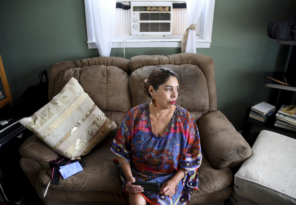 Lucy Molina sits in her living room in Commerce City, Colo., on Tuesday, July 25, 2023. Without central air conditioning, the single mother's home in one of the Denver metro's poorest areas has reached 107 degrees Fahrenheit (41.7 Celsius), she said. America's poorest residents and people of color are far more likely to face grueling heat without air conditioning to keep their body temperatures down, according to a Boston University analysis of 115 U.S. cities. (AP Photo/Thomas Peipert)