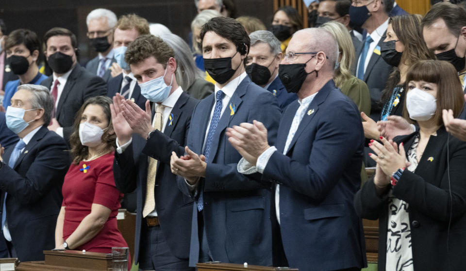 Canadian Prime Minister Justin Trudeau stands and applauds with members of parliament following an address by Ukrainian President Volodymyr Zelenskyy to parliament, Tuesday, March 15, 2022 in Ottawa. (Adrian Wyld/The Canadian Press via AP)