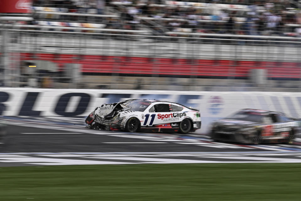 Denny Hamlin (11) crashes on the front stretch during a NASCAR Cup Series auto race at Charlotte Motor Speedway, Monday, May 29, 2023, in Concord, N.C. (AP Photo/Matt Kelley)