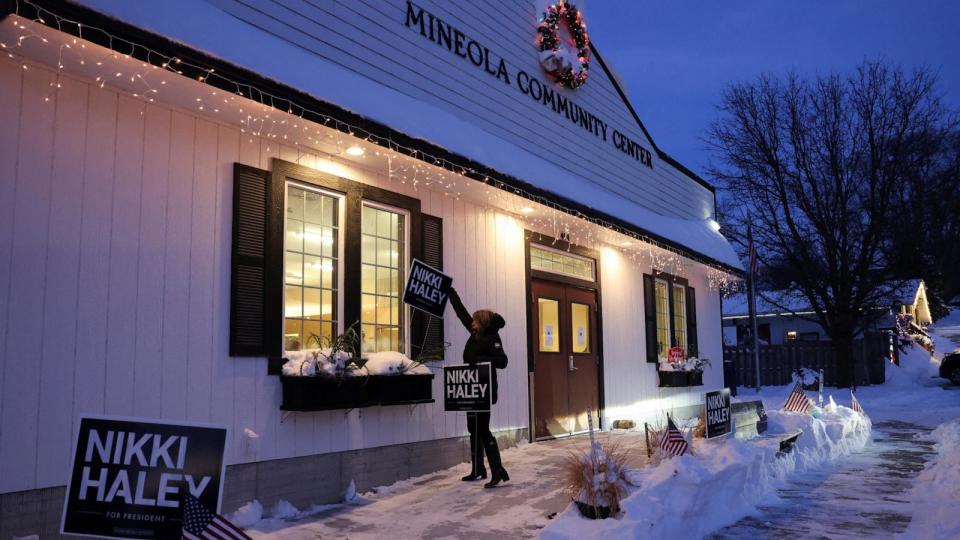 PHOTO: Deshawne Bird-Sell sets up signs for Republican presidential candidate and former U.S. Ambassador to the United Nations Nikki Haley outside the Mineola Community Center in Mineola, Iowa, Jan. 15, 2024.  (Scott Morgan/Reuters)