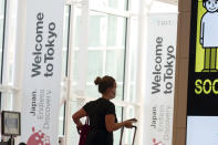 One of foreign travelers walks upon arrival at the Haneda International Airport Tuesday, Oct. 11, 2022, in Tokyo. Japan's strict border restrictions are eased, allowing tourists to easily enter for the first time since the start of the COVID-19 pandemic. Independent tourists are again welcomed, not just those traveling with authorized groups. (AP Photo/Eugene Hoshiko)