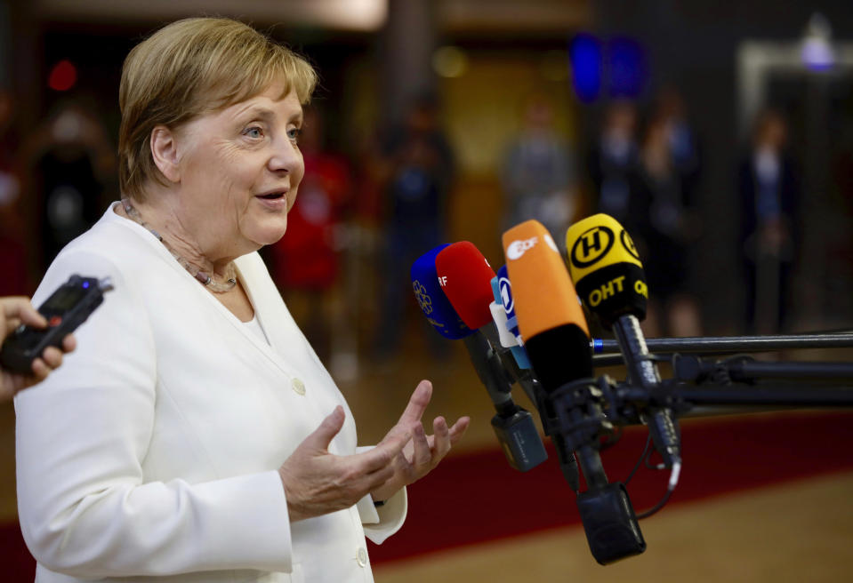 German Chancellor Angela Merkel speaks with the media as she arrives for an EU summit in Brussels, Sunday, June 30, 2019. European Union leaders have started another marathon session of talks desperately seeking a breakthrough in a diplomatic fight over who should be picked for a half dozen of jobs at the top of EU institutions. (AP Photo/Olivier Matthys)