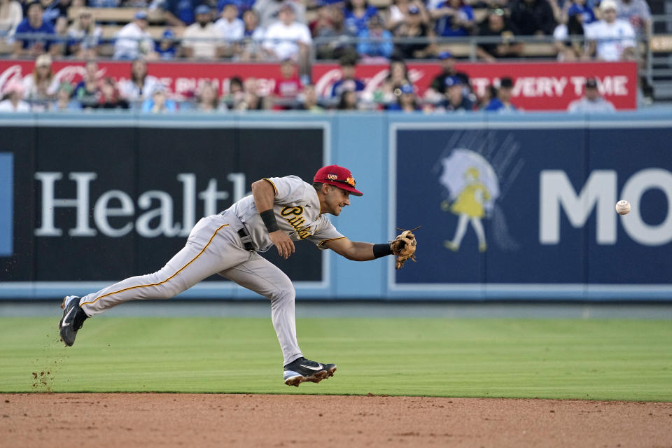 Pittsburgh Pirates shortstop Nick Gonzales can't reach a ball hit for a single by Los Angeles Dodgers' Jason Heyward during the second inning of a baseball game Tuesday, July 4, 2023, in Los Angeles. (AP Photo/Mark J. Terrill)