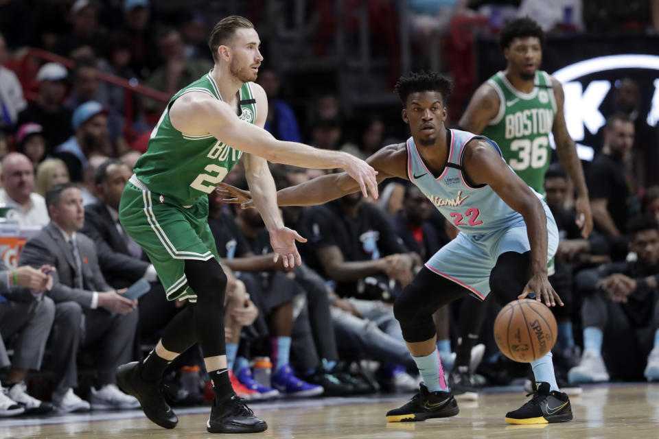 Boston Celtics forward Gordon Hayward, left, passes as Miami Heat forward Jimmy Butler (22) defends during the first half of an NBA basketball game, Tuesday, Jan. 28, 2020, in Miami. (AP Photo/Lynne Sladky)