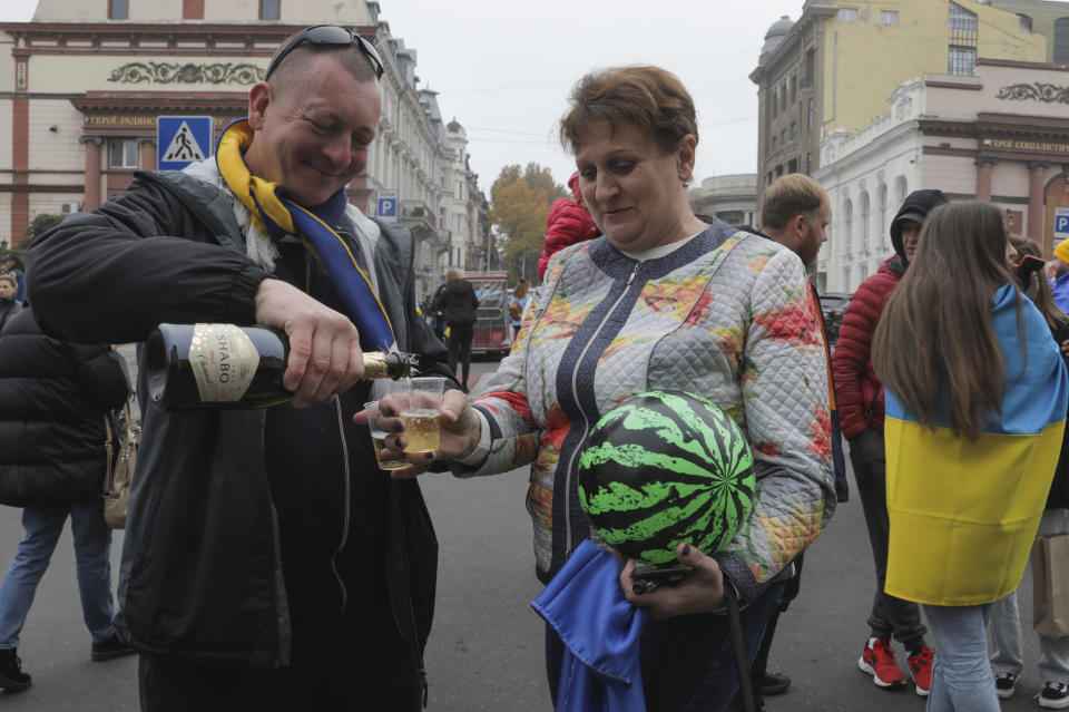 Ukrainians gather in downtown to celebrate the recapturing of Kherson city, Ukraine, Odesa, Saturday, Nov. 12, 2022. People across Ukraine awoke from a night of jubilant celebrating after the Kremlin announced its troops had withdrawn to the other side of the Dnieper River from Kherson, the only regional capital captured by Russia's military during the ongoing invasion. (AP Photo/Nina Lyashonok)