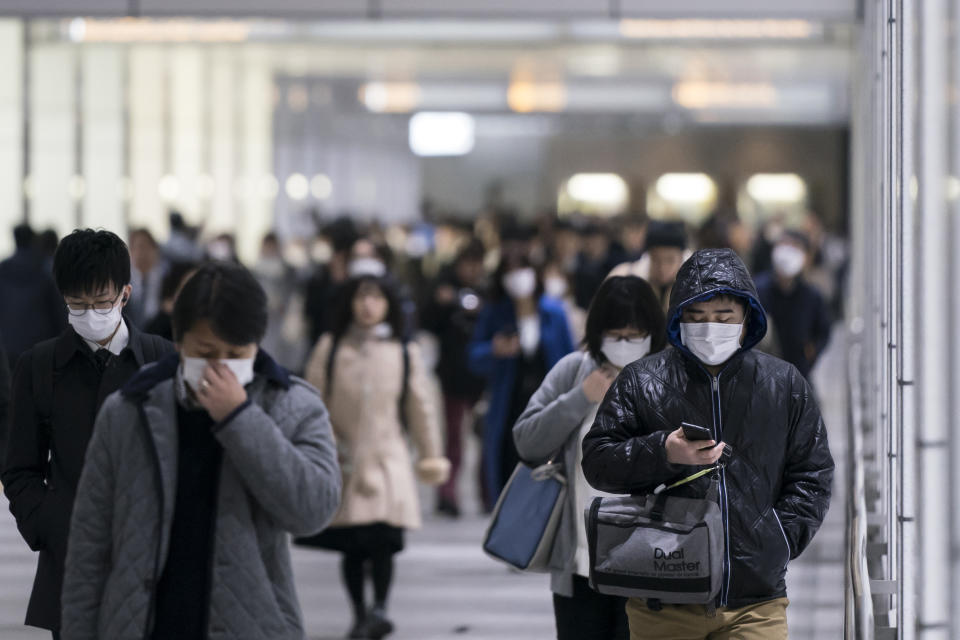 TOKYO, JAPAN - FEBRUARY 13: Pedestrians wearing face masks walk through an underground passage on February 13, 2020 in Tokyo, Japan. At least 219 passengers and crew onboard the Diamond Princess cruise ship have tested positive for COVID-19 making it the biggest centre of the virus outside China. Japan has also so far diagnosed 28 other people with the illness, some of whom are evacuees from Wuhan, and has announced measures to ban entry to foreign travelers from Zhejiang alongside an existing ban on non-Japanese nationals coming from Hubei. (Photo by Tomohiro Ohsumi/Getty Images)