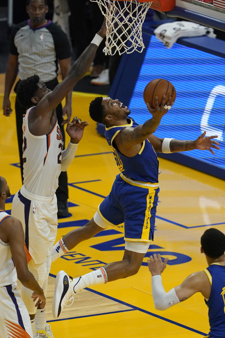 Golden State Warriors forward Kent Bazemore, right, shoots against Phoenix Suns center Deandre Ayton during the first half of an NBA basketball game in San Francisco, Tuesday, May 11, 2021. (AP Photo/Jeff Chiu)