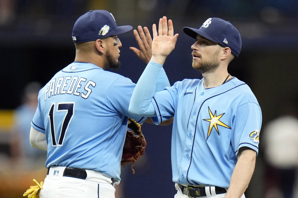 Tampa Bay Rays second baseman Brandon Lowe high fives third baseman Isaac Paredes (17) after the team defeated the Oakland Athletics during a baseball game Sunday, April 9, 2023, in St. Petersburg, Fla. (AP Photo/Chris O'Meara)