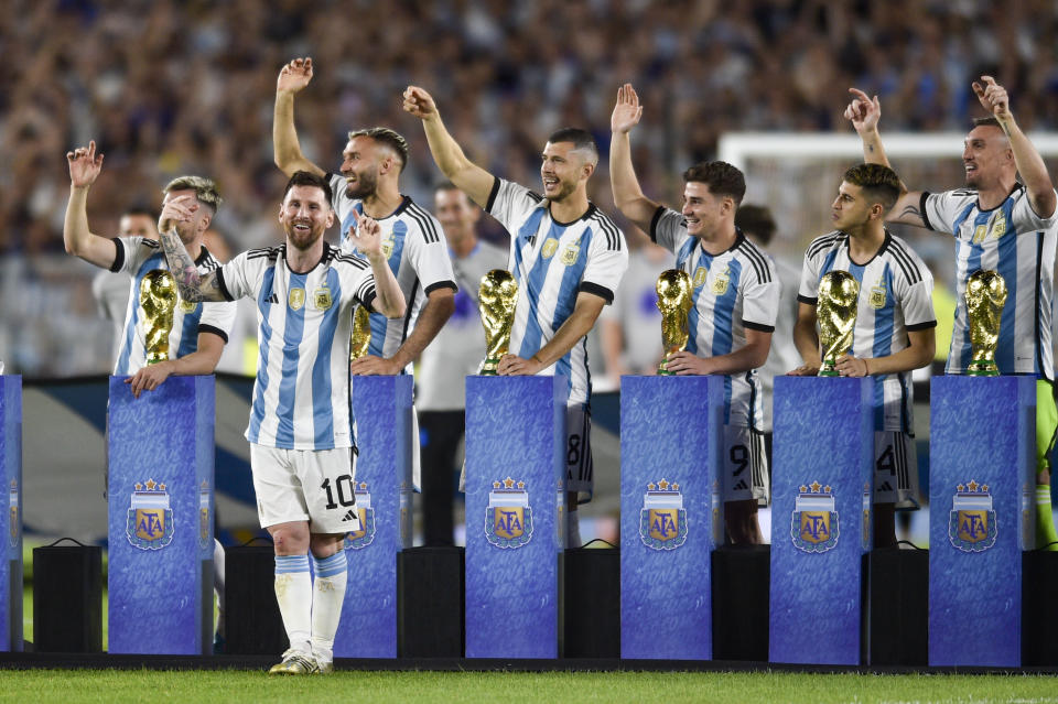 Argentina's Lionel Messi and teammate celebrate with replicas of the FIFA World Cup trophy after an international friendly soccer match against Panama in Buenos Aires, Argentina, Thursday, March 23, 2023. (AP Photo/Gustavo Garello)