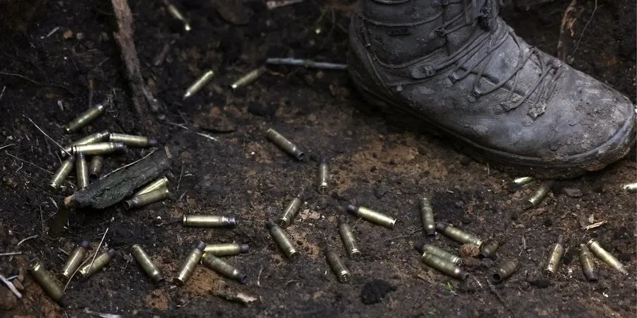 Shell casings on the ground in a trench near the frontline in the east
