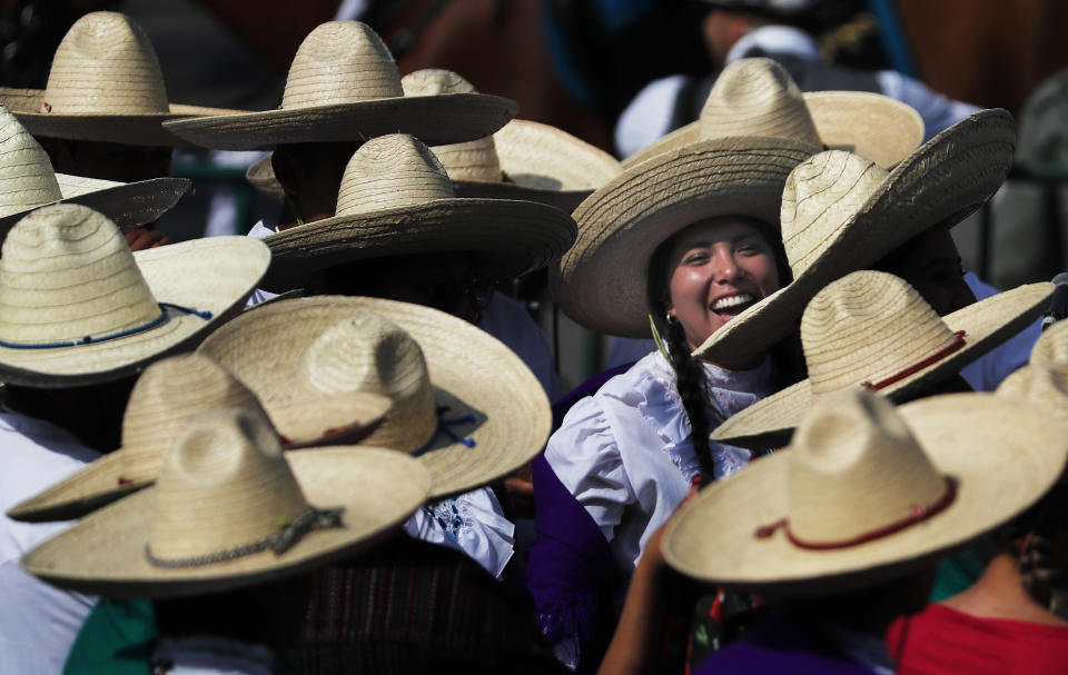 Women dressed as Adelitas, or women soldiers, gather to take part in a parade marking the 109th anniversary of the Mexican Revolution, at the Zocalo in Mexico City, Wednesday, Nov. 20, 2019. More than a 1,000 participants dressed in time period clothing are expected to act out historical scenes. (AP Photo/Marco Ugarte)