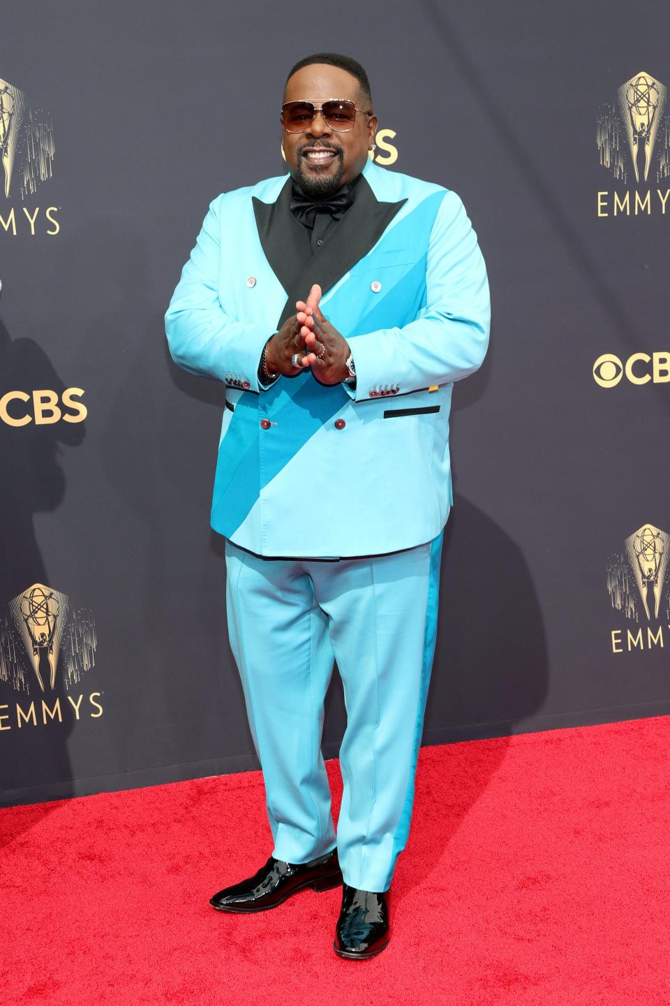 Cedric The Entertainer wears a blue suit on the Emmys red carpet.