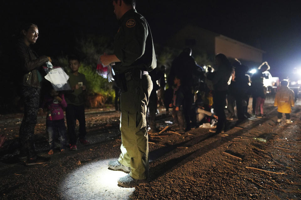 FILE - Immigrants are processed by the U.S. Border Patrol after crossing the Rio Grande on May 22, 2021, in Roma, Texas. Biden took office on Jan. 20 and almost immediately, numbers of migrants exceeded expectations. (Joel Martinez/The Monitor via AP, File)