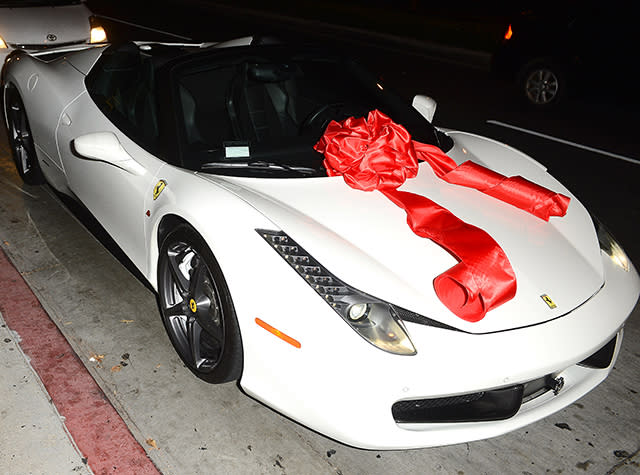 How's this for a birthday gift?! Rapper Tyga, 25, brought out the big guns for his reported girlfriend Kylie Jenner's 18th birthday, gifting the youngest member of the Kardashian clan with a white Ferrari. Kylie's actual birthday is today, though she celebrated in style on Sunday night at Bootsy Bellows nightclub in Hollywood. The luxury car is reportedly a Ferrari 482 Italia, worth $320,000. <strong>WATCH: Kanye West on Tyga and Kylie -- 'I Think He Got in Early, I Think He Was Smart'</strong> All Access Photo Agency Obviously, the birthday girl was pleased with the gift. "So crazy," the reality star said on tape, in awe of her new ride. "This is my dream." All Access Photo Agency Of course, Kylie's mom, Kris Jenner, couldn't resist taking a ride with Kylie, the two posing for pics. All Access Photo Agency The now legal <em>Keeping Up With the Kardashians</em> star went blonde for her big day, surrounded by her famous family. Her sisters Kendall Jenner, Kim Kardashian, Kourtney Kardashian, and Khloe Kardashian were all in attendance at the big bash, as well as Kanye West and Khloe's reported boyfriend, NBA star James Harden. Caitlyn Jenner was also at the festivities, Kylie captioning this group pic, "MY GIRLS. party night. #18@12." Fetty Wap provided the party entertainment, performing his big hit, "Trap Queen." The festivities appeared to be too much for 38-year-old Kanye to handle. Kim posted this picture of the "Only One" rapper all tuckered out by the end of the night. Though nobody's probably happier about Kylie's big day than Tyga. The "Rack City" rapper Instagrammed a racy pic of his reported girlfriend on Monday, writing, "Happy bday to the dopest girl ever!" <strong>WATCH: Khloe Kardashian Hugs It Out With Kylie Jenner and Tyga</strong> Late last month, Khloe defended Kylie and Tyga's reported relationship, telling <em>Complex</em>, "I think at 16 I was probably f**king someone that was in their 20s, for sure. I wouldn't say I was even dating, probably just sleeping with them. But again Kylie is not a normal 17-year-old." "Kylie is taking business meetings and bought her first house, or she's going on a private plane with Karl Lagerfeld to take a meeting," she added. "That's not even what people do in their 30s. It's a rare circumstance, so let's treat this as a special case." Watch below: