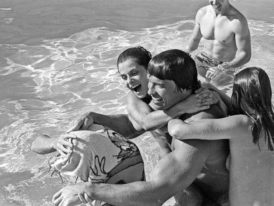 Arnold Schwarzenegger in a swimming pool with Nastassja Kinski and Debra Tate, sister of the late actress Sharon Tate, in Los Angeles, California