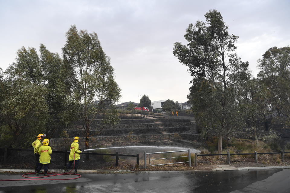 CFA firefighters are seen after a fire impacted Clovemont Way, Bundoora in Melbourne, Monday, December 30, 2019.