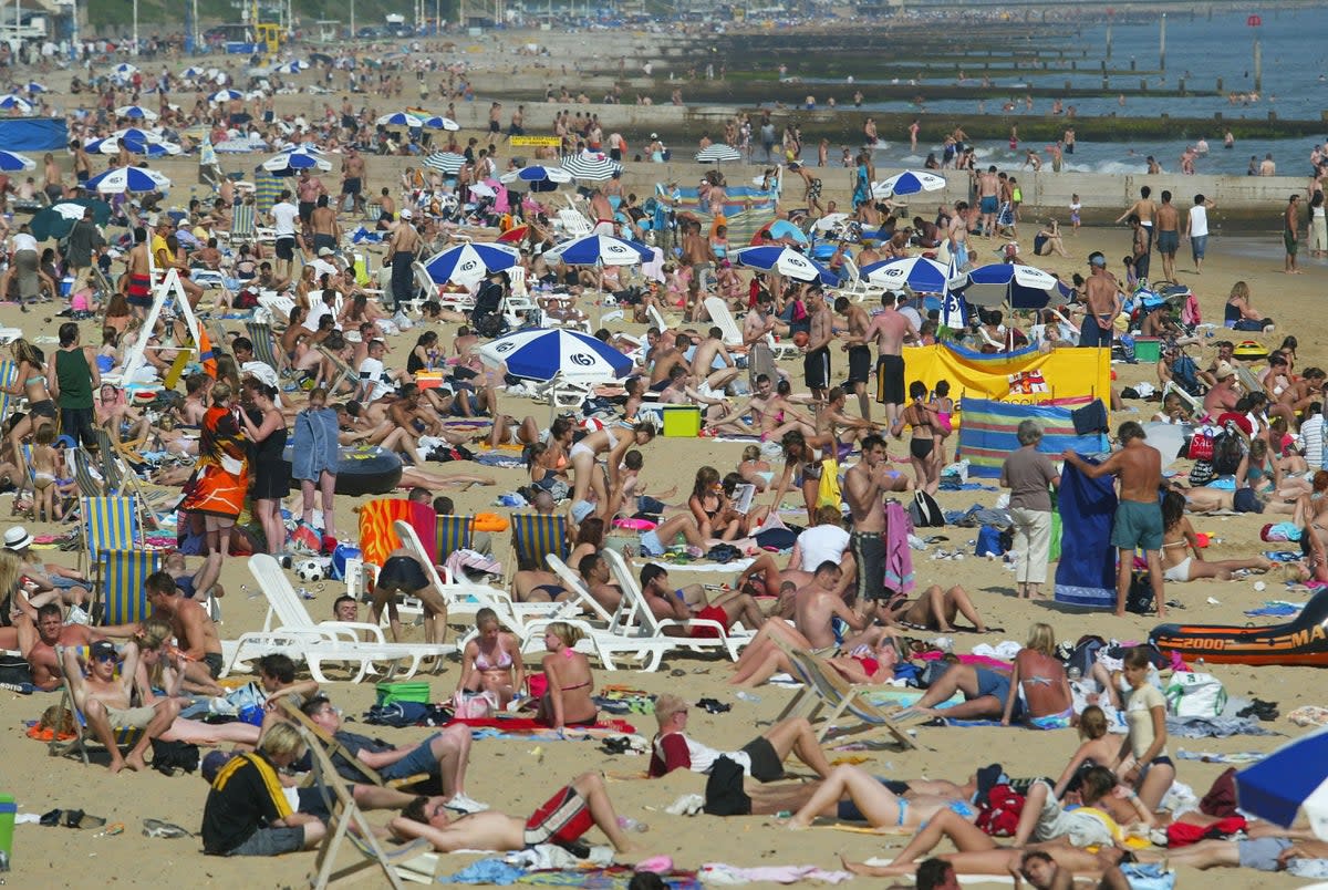 People bask in the sun on Bournemouth beach on July 15, 2003 in Bournemouth, England (Getty Images)