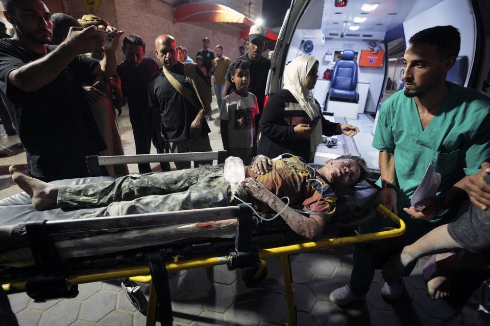 A Palestinian wounded in an Israeli bombardment on the Gaza Strip is brought to Al Aqsa hospital in Deir al Balah (Abdel Kareem Hana / AP)
