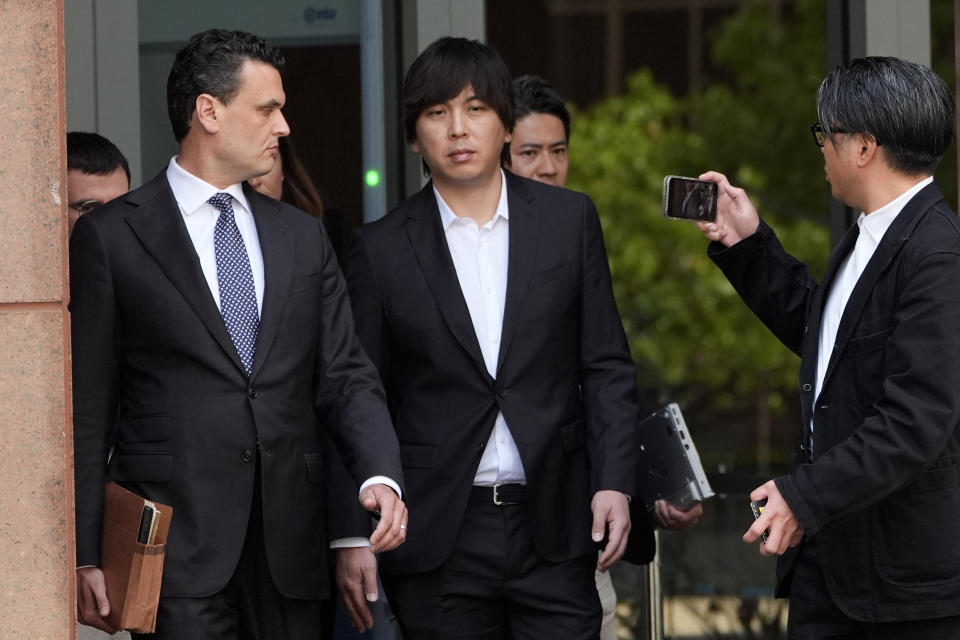 Ippei Mizuhara, center, the former longtime interpreter for the Los Angeles Dodgers baseball star Shohei Ohtani, leaves federal court following his arraignment, Tuesday, May 14, 2024, in Los Angeles. Mizuhara pleaded not guilty Tuesday to bank and tax fraud, a formality ahead of a plea deal he’s negotiated with federal prosecutors in a wide-ranging sports betting case. (AP Photo/Damian Dovarganes)