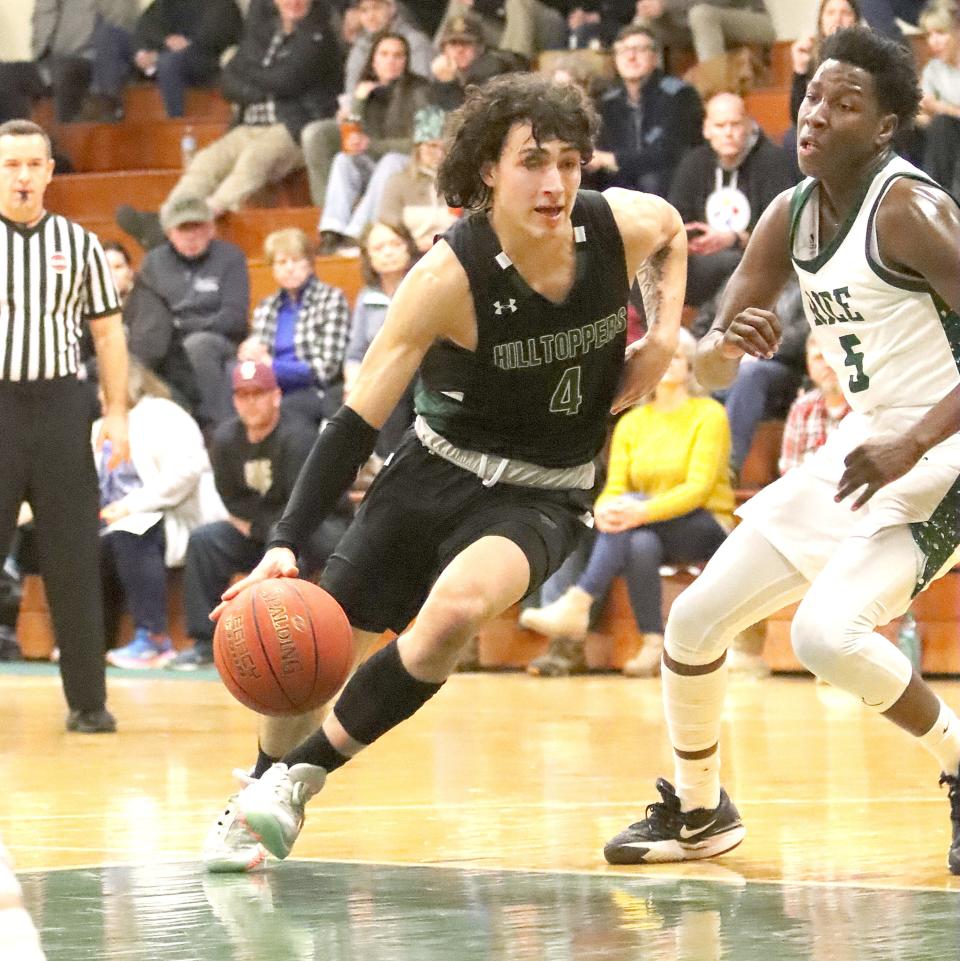 St. Johnsbury's Harry Geng drives into the paint during the Hilltoppers' 79-64 loss to the Green Knights on Thursday night at RHS.