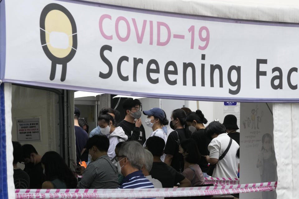 People wait to get coronavirus testing at a Public Health Center in Seoul, South Korea, Sunday, July 11, 2021. (AP Photo/Ahn Young-joon)