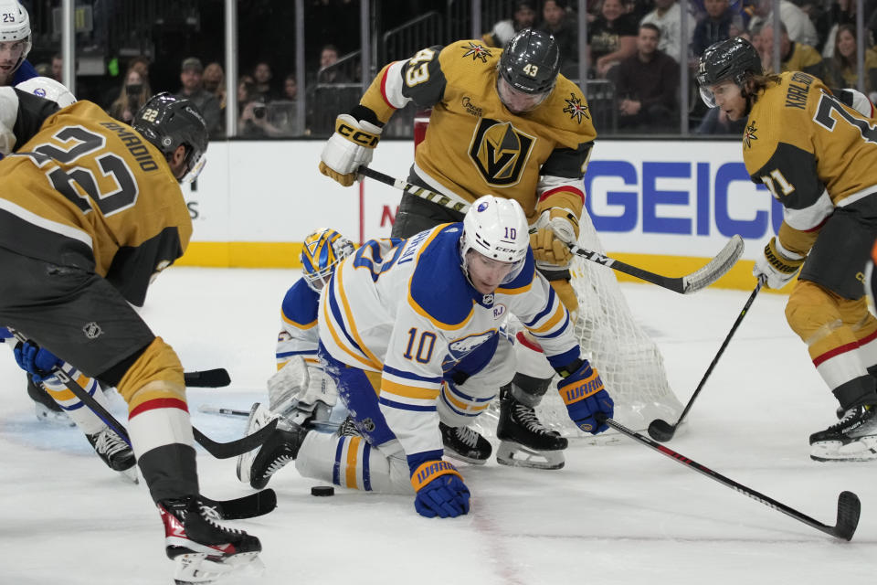 Buffalo Sabres defenseman Henri Jokiharju (10) defends against Vegas Golden Knights right wing Michael Amadio (22) and center Paul Cotter (43) during the second period of an NHL hockey game Friday, Dec. 15, 2023, in Las Vegas. (AP Photo/John Locher)