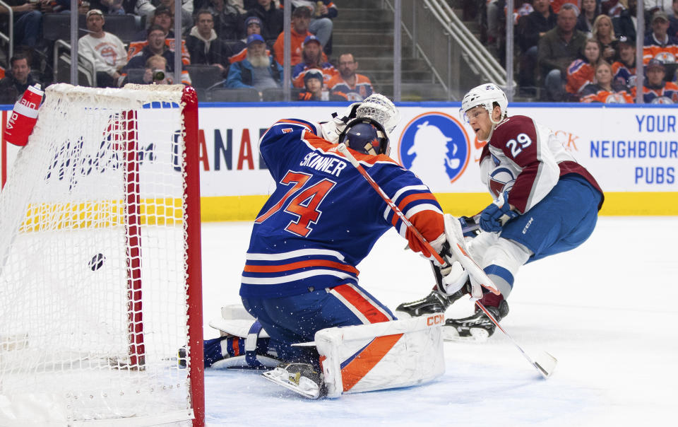 Colorado Avalanche center Nathan MacKinnon (29) scores on Edmonton Oilers goalie Stuart Skinner (74) during the third period of an NHL hockey game Saturday, Jan. 7, 2023, in Edmonton, Alberta. (Jason Franson/The Canadian Press via AP)