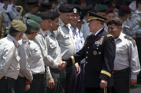 Chairman of the Joint Chiefs of Staff U.S. Army General Martin Dempsey (2ndR) and Israel's Chief of Staff Lieutenant General Gadi Eizenkot (R) greet Israeli army officers during a welcoming ceremony for Dempsey in Tel Aviv June 9, 2015. REUTERS/Baz Ratner
