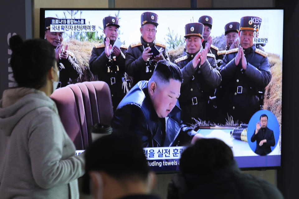 People watches a television screen showing a file image of North Korean leader Kim Jong Un during a news program at the Seoul Railway Station in Seoul, South Korea, Saturday, March 21, 2020. North Korea on Saturday fired two presumed short-range ballistic missiles into the sea, South Korea's military said, as it continues to expand military capabilities amid deadlocked nuclear negotiations with the Trump administration and a crippling global health crisis. (AP Photo/Ahn Young-joon)