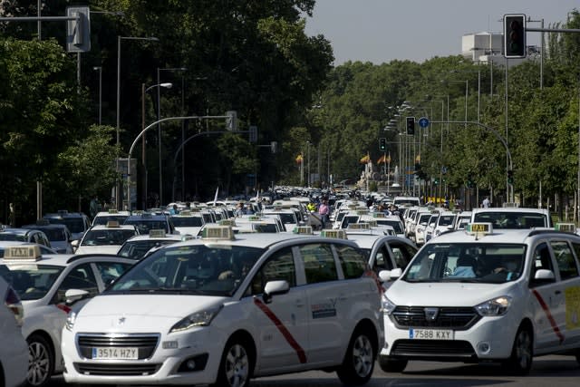 Taxi drivers block a main avenue during a taxi driver protest in Madrid (Manu Fernandez/AP)