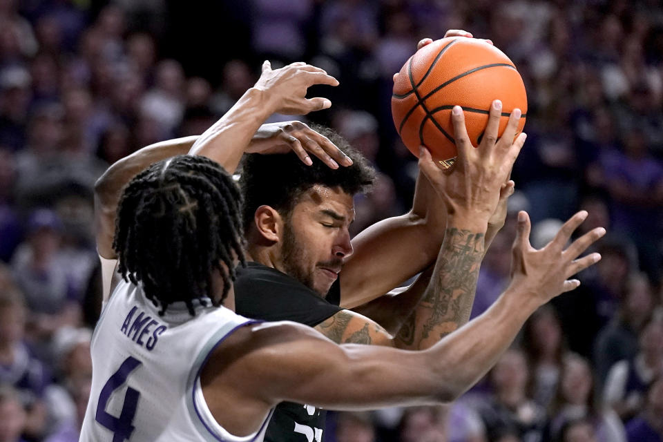 Kansas State guard Darrin Ames (4) tries to steal the ball from North Alabama forward Damian Forrest during the first half of an NCAA college basketball game Saturday, Dec. 2, 2023, in Manhattan, Kan. (AP Photo/Charlie Riedel)