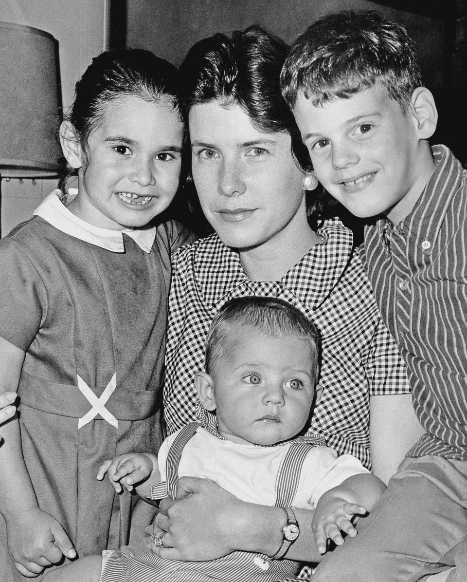 FILE - In this May 3, 1965, file photo, Shirley Ann Grau, winner of a Pulitzer for her third novel "The Keepers of the House," is shown in New Orleans, with her children, Nora, 5, William, 6 months, and Ian, 8. Grau, a Pulitzer Prize-winning fiction writer whose stories and novels told of both the dark secrets and the beauty of the Deep South, has died at age 91. Her daughter Nora McAlister said Wednesday, Aug. 5, 2020, that Grau died Monday in a memory care facility of complications from a stroke. (AP Photo, File)