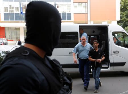 Police escort to the court a Syrian migrant who was put on trial for illegal border crossing, ahead of his court sentencing in Szeged, Hungary, July 1, 2016. REUTERS/Laszlo Balogh