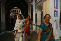 In this Nov. 30, 2018 photo, Indian tourists visit the Ram Janaki temple in Janakpur, Nepal. Millions of Hindu devotees travel every year to the temple where the Hindu goddess Sita is believed to have been born and later married the Hindu god Ram. A new rail line connecting the 34 kilometers (21 miles) between Janakpur in southeastern Nepal and Jay Nagar in the Indian state of Bihar are raising hopes for new business and pilgrimages. (AP Photo/Niranjan Shrestha)