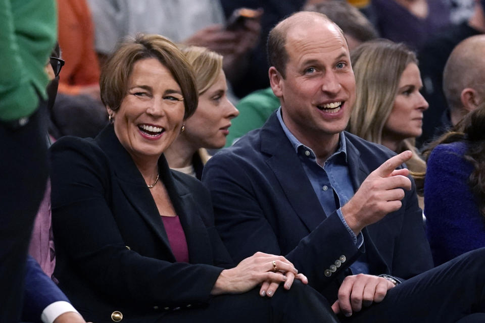 Britain's Prince William jokes with Massachusetts Gov.-elect Maura Healey during the first half of an NBA basketball game between the Miami Heat and the Boston Celtics on Wednesday, Nov. 30, 2022, in Boston. (AP Photo/Charles Krupa)