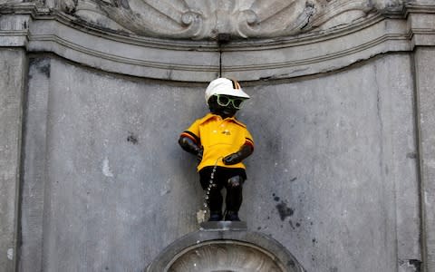 The Manneken Pis dressed in the overall leader's yellow jersey at the start of the Tour de France in Brussels.  - Credit: Reuters