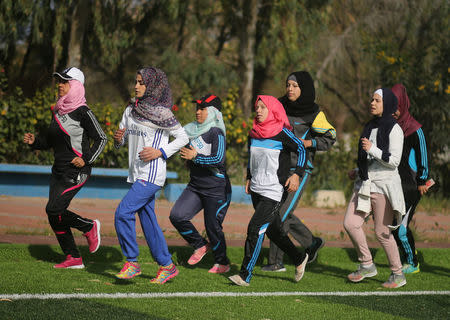 Palestinian women run during a baseball training session in Khan Younis in the southern Gaza Strip March 19, 2017. REUTERS/Mohammed Salem