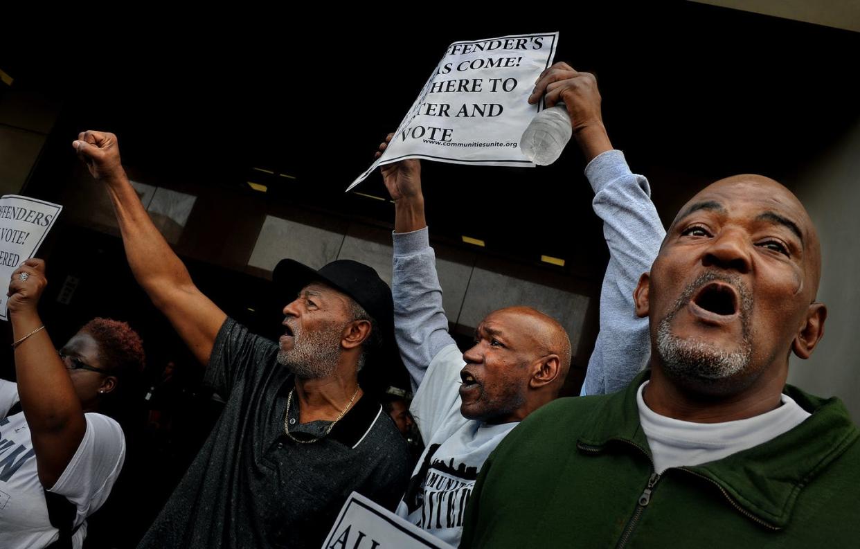 <span class="caption">Gerald Dent, left, is joined by James Featherstone and Niles Ringgold at a rally for felon voting rights, in Baltimore, Maryland, on March 10, 2020.</span> <span class="attribution"><a class="link " href="https://www.gettyimages.com/detail/news-photo/gerald-dent-who-served-41-years-in-prison-joined-james-news-photo/514752658?adppopup=true" rel="nofollow noopener" target="_blank" data-ylk="slk:Michael S. Williamson/The Washington Post via Getty Images;elm:context_link;itc:0;sec:content-canvas">Michael S. Williamson/The Washington Post via Getty Images</a></span>