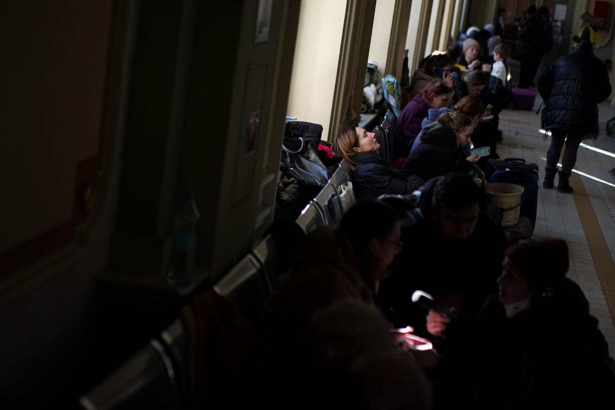 Refugees that fled the war in Ukraine wait at the Przemysl train station, southeastern Poland, on Saturday, March 12, 2022. (AP Photo/Daniel Cole)