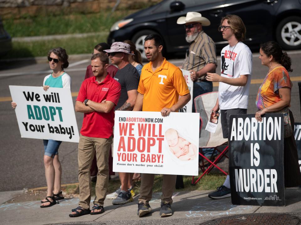 Anti-abortion demonstrators gather outside the Knoxville Center for Reproductive Health in Knoxville, Tenn. on Friday, June 17, 2022. 