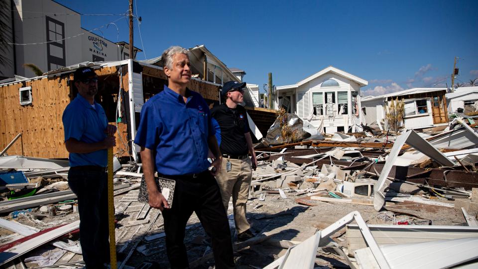 Dan Noah, Rodney Wynn and Austen Flannery, all meteorologists for the National Weather Service assess Hurricane Ian damage including storm surge heights on homes on San Carlos Island next to Fort Myers Beach on Tuesday, Oct. 4, 2022. 