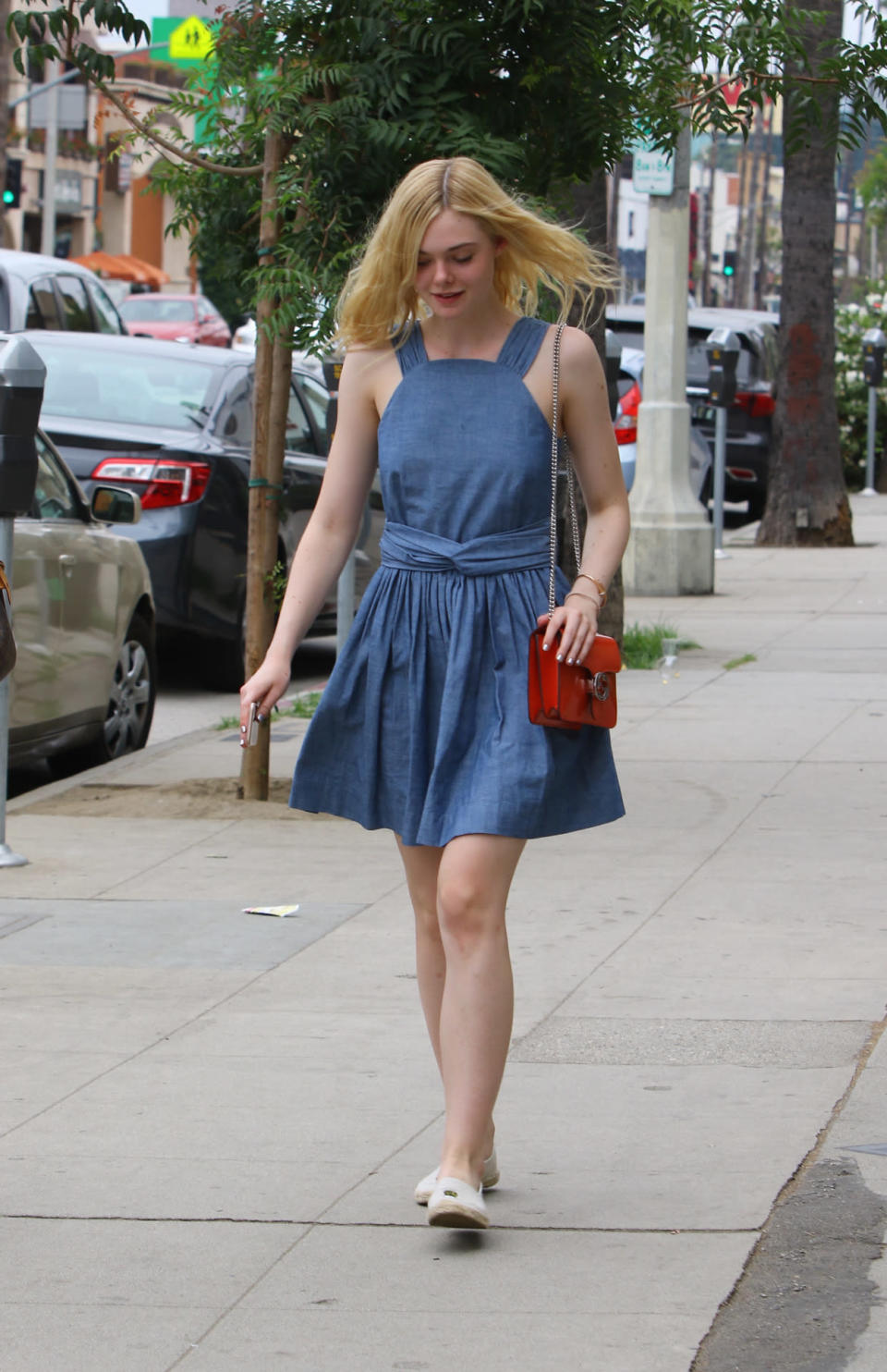 Elle Fanning in a denim dress with a Gucci bag on the streets of Los Angeles, Calif.