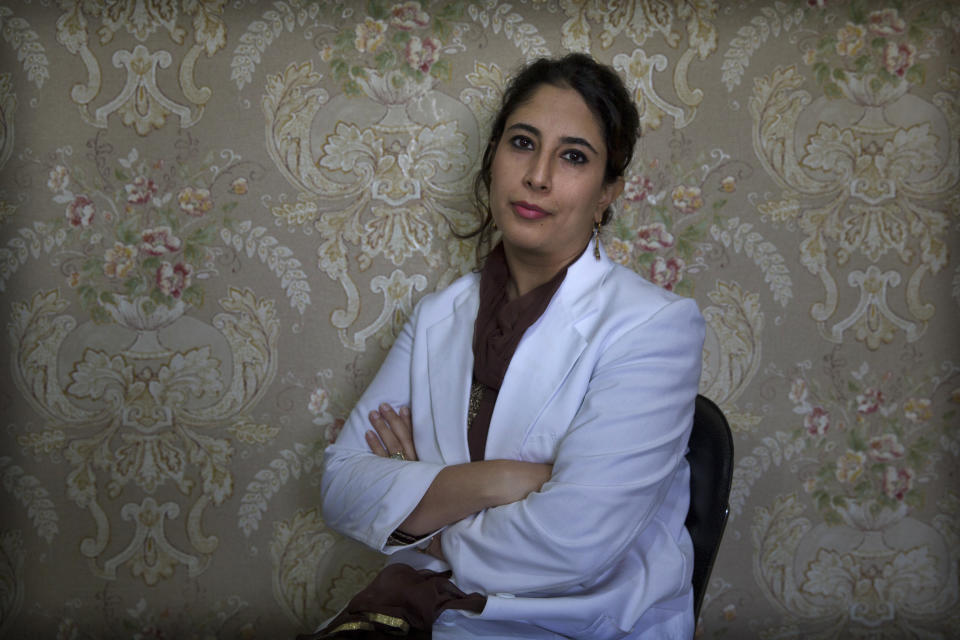 In this Sept. 27, 2019, photo, a Kashmiri doctor Sabahat Rasool sits for a photograph inside her clinic in Srinagar, Indian controlled Kashmir. Rasool tells the story of a pregnant woman who refused to be admitted in hospital because “there was no way she could communicate with her family and tell them that she needed to be admitted.” She was brought in unconscious the next day. “She survived but lost her unborn baby all because she could not afford to stay back the previous night for fear her family would think she was missing or kidnapped.” (AP Photo/ Dar Yasin)