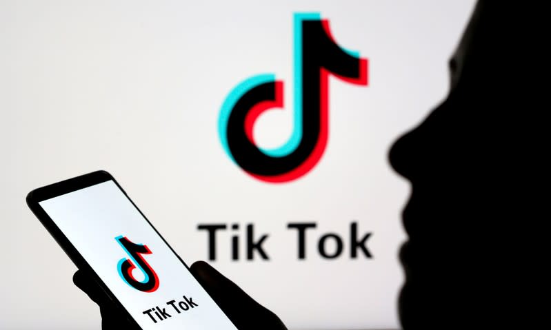 FILE PHOTO: Person holds a smartphone with Tik Tok logo displayed in this picture illustration