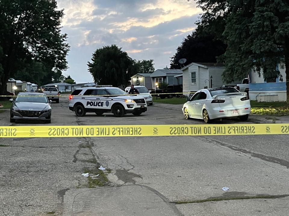 Investigators returned to the scene of a mobile home park in Clark County the day after a Clark County deputy was shot and later died from his injuries. A memorial outside the house has started to grow with two deputies arriving at the scene and placing flowers outside the house. (Gabrielle Enright/Staff)