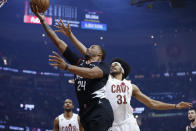 Los Angeles Clippers forward Norman Powell (24) shoots against Cleveland Cavaliers center Jarrett Allen (31) during the first half of an NBA basketball game, Sunday, Jan. 29, 2023, in Cleveland. (AP Photo/Ron Schwane)