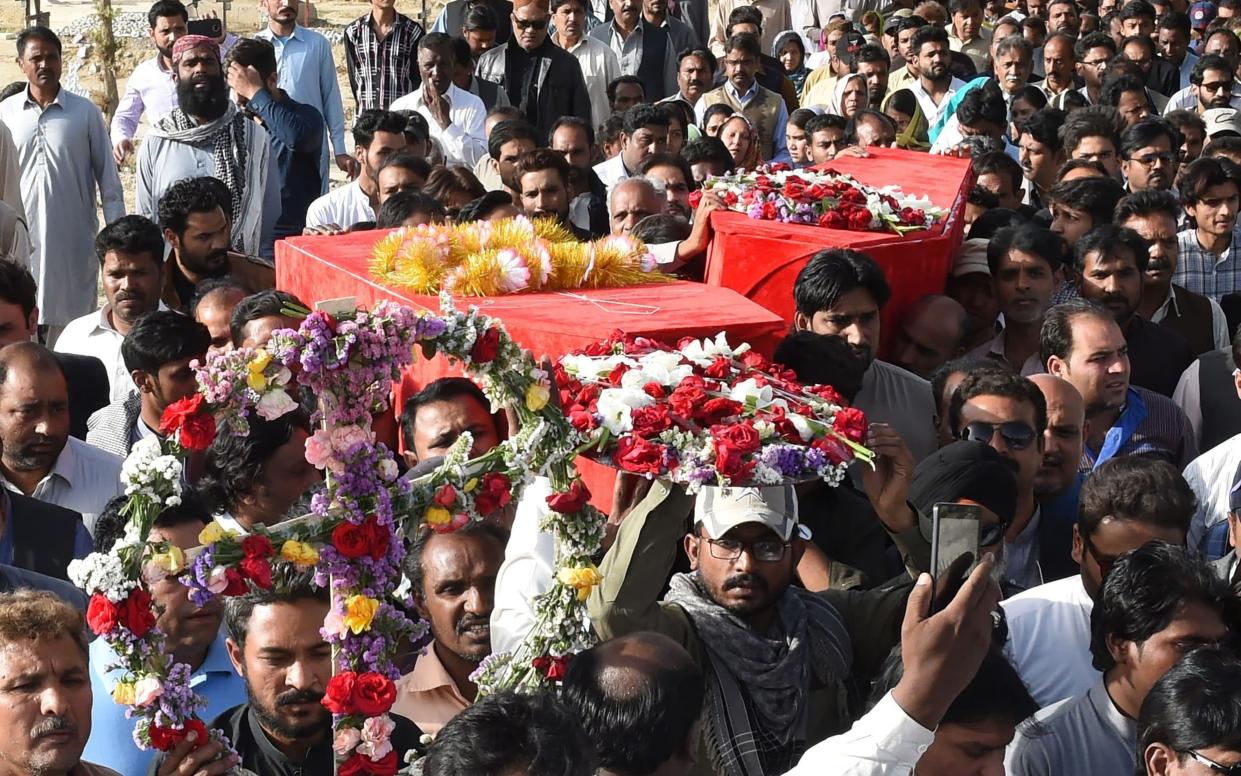 Pakistani Christians carry the coffins of their community members - AFP