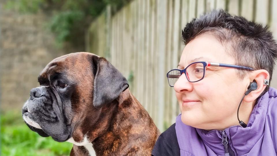 Boxer dog sitting next to owner