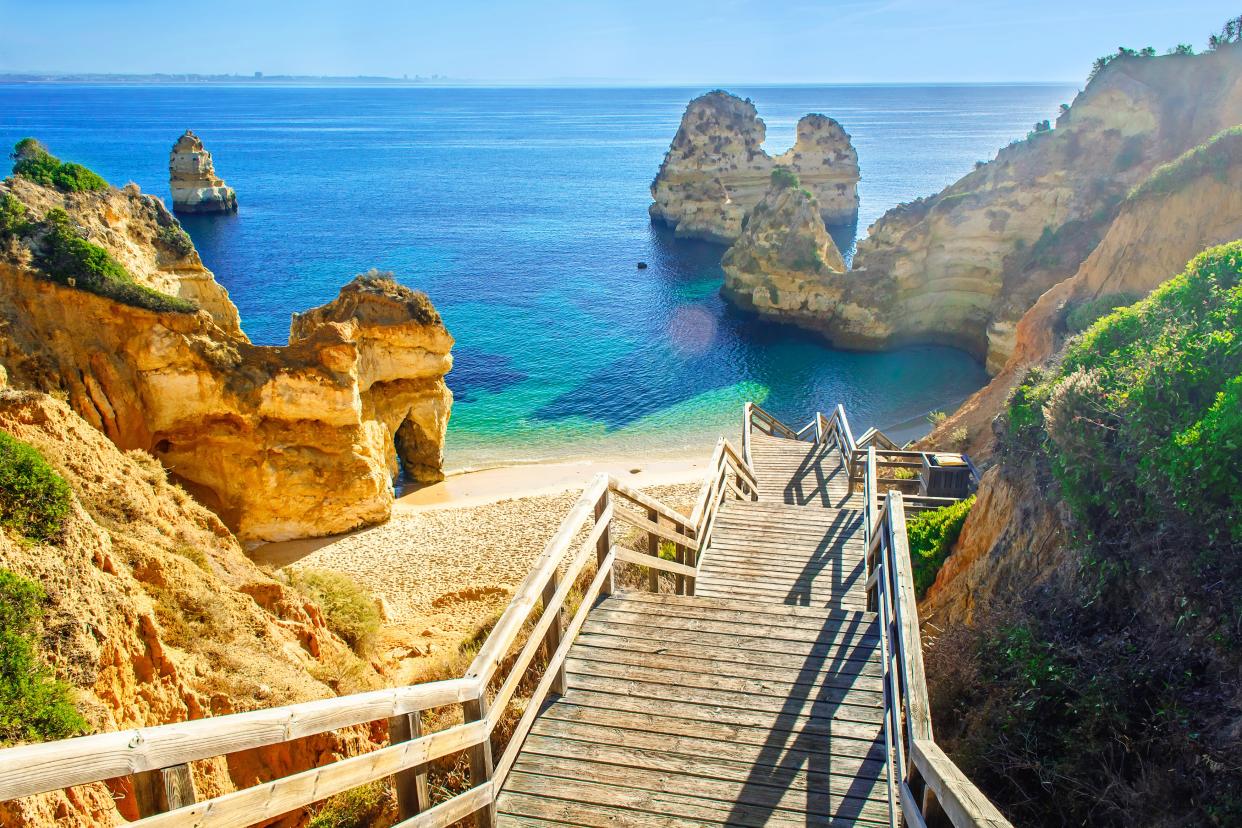 A wooden footbridge leads to the beach at Praia do Camilo in Portugal’s Algarve region (Getty Images/iStockphoto)